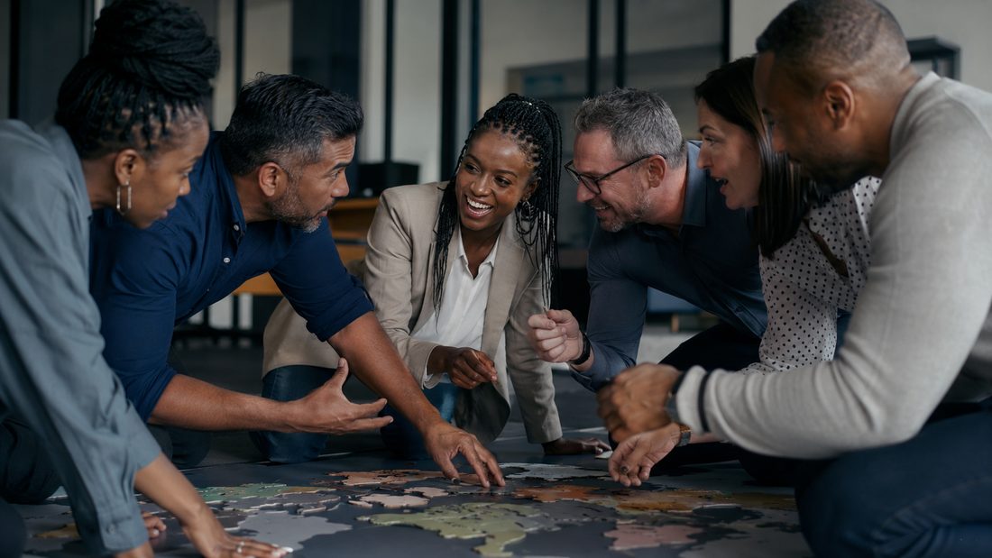 A leadership team working together around a shared floor map