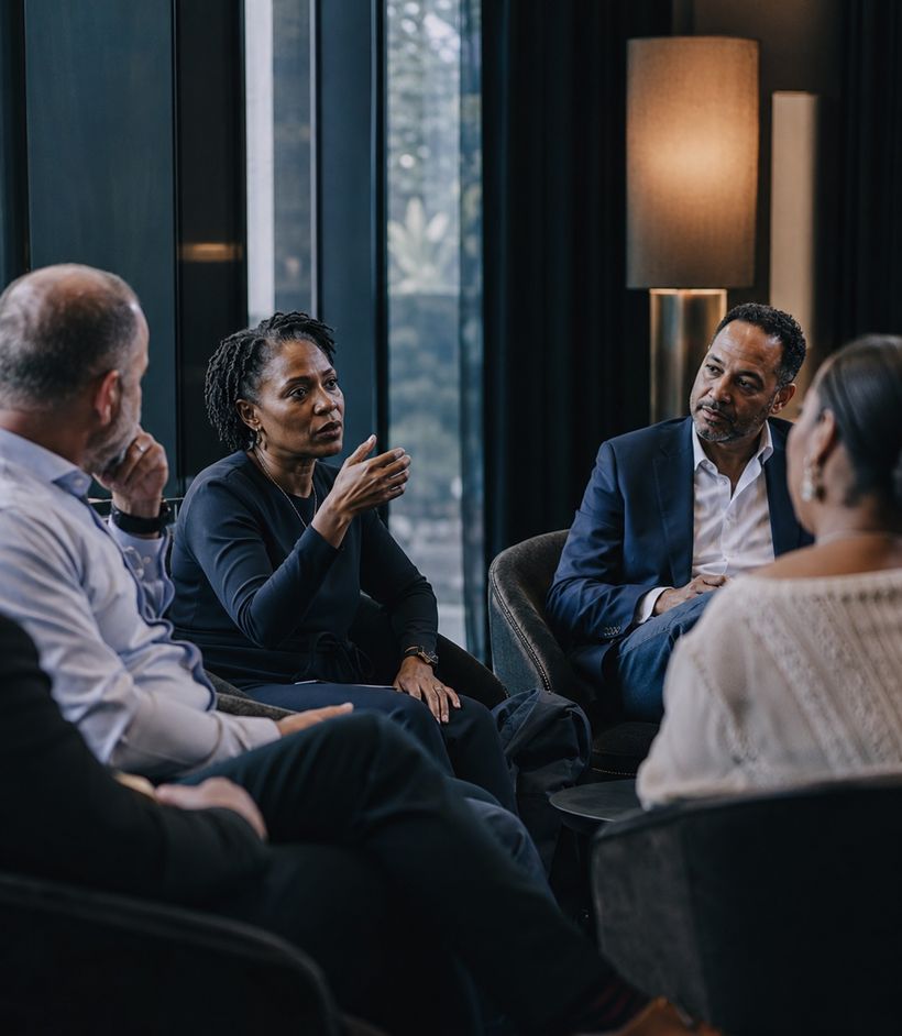Executives in an intimate peer forum discussion