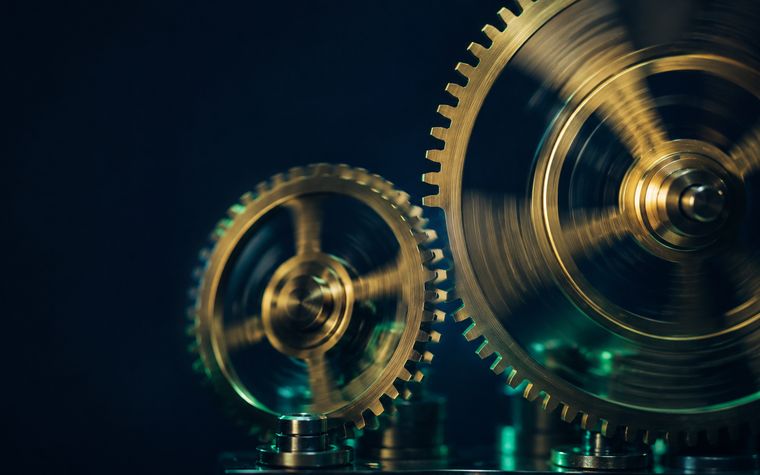 Polished gears spinning fast with a gap where two never mesh